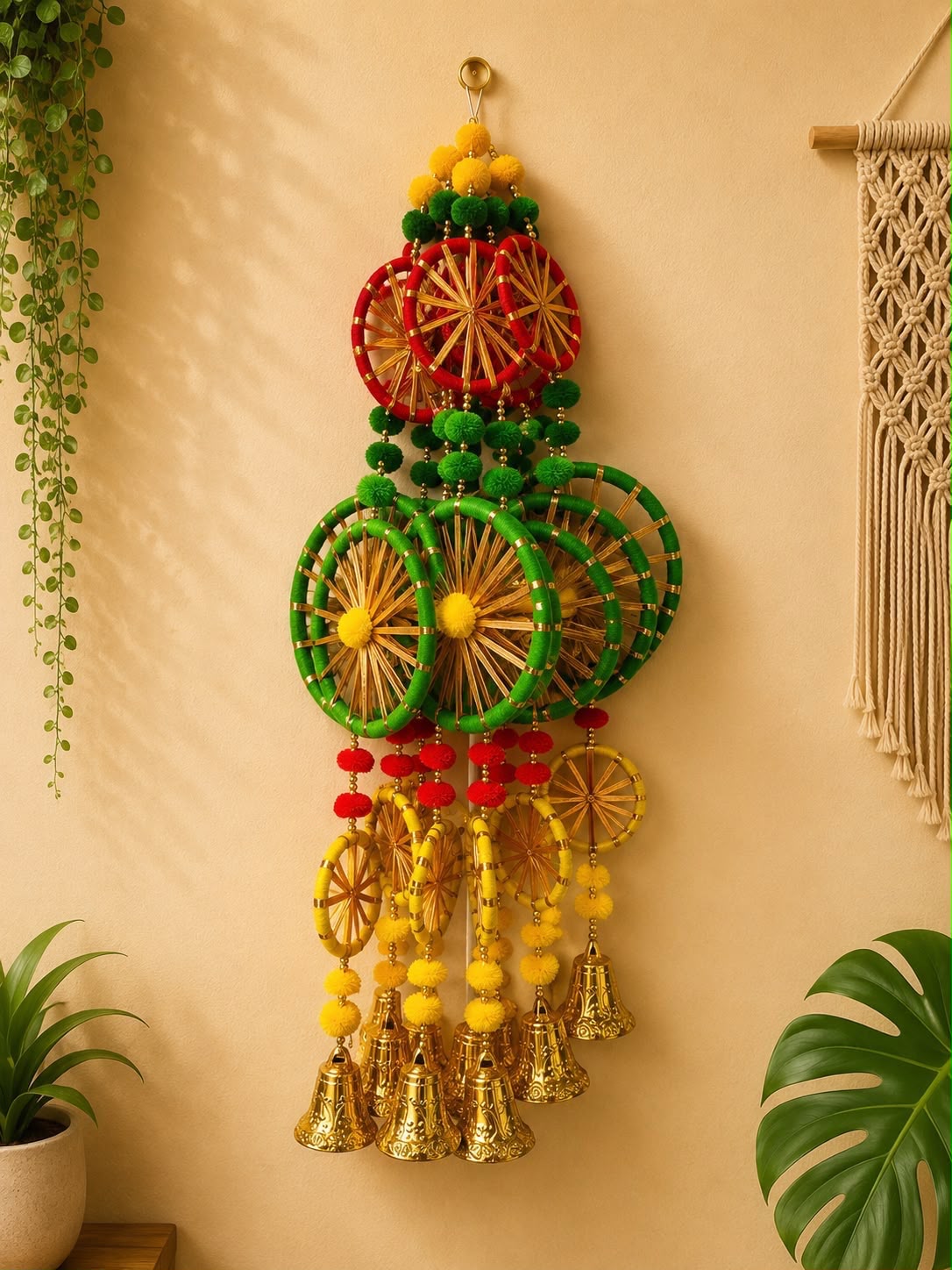 Multicolour woven wheel Diwali door hanging with pom-poms and brass bells in red, green and yellow