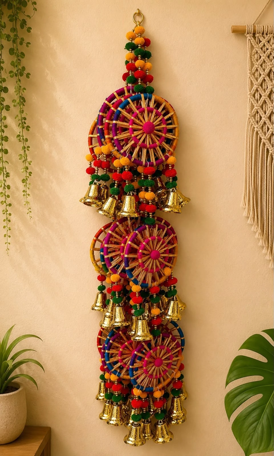 Multicolour woven wheel Diwali door hanging with pom-poms, beads and hanging brass bells