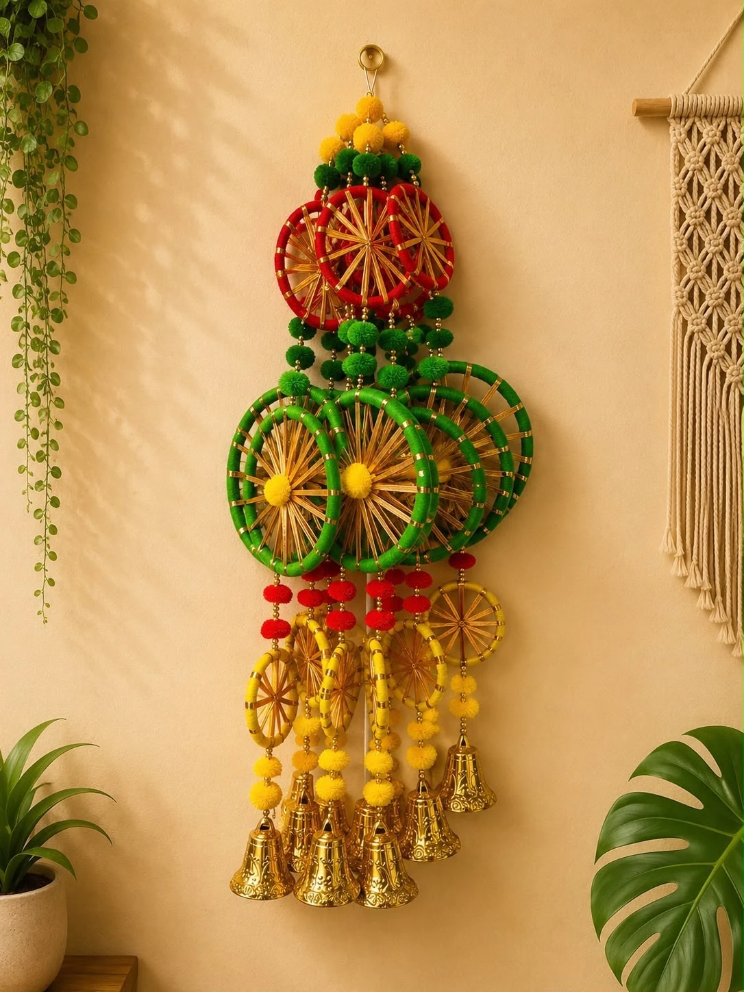 Multicolour woven wheel Diwali door hanging with pom-poms and brass bells in red, green and yellow