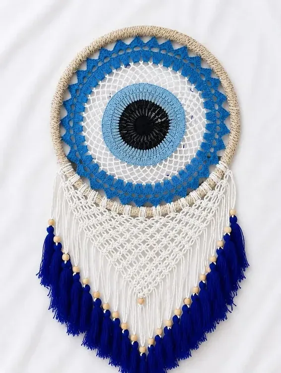 Evil eye macramé wall hanging in blue and white
